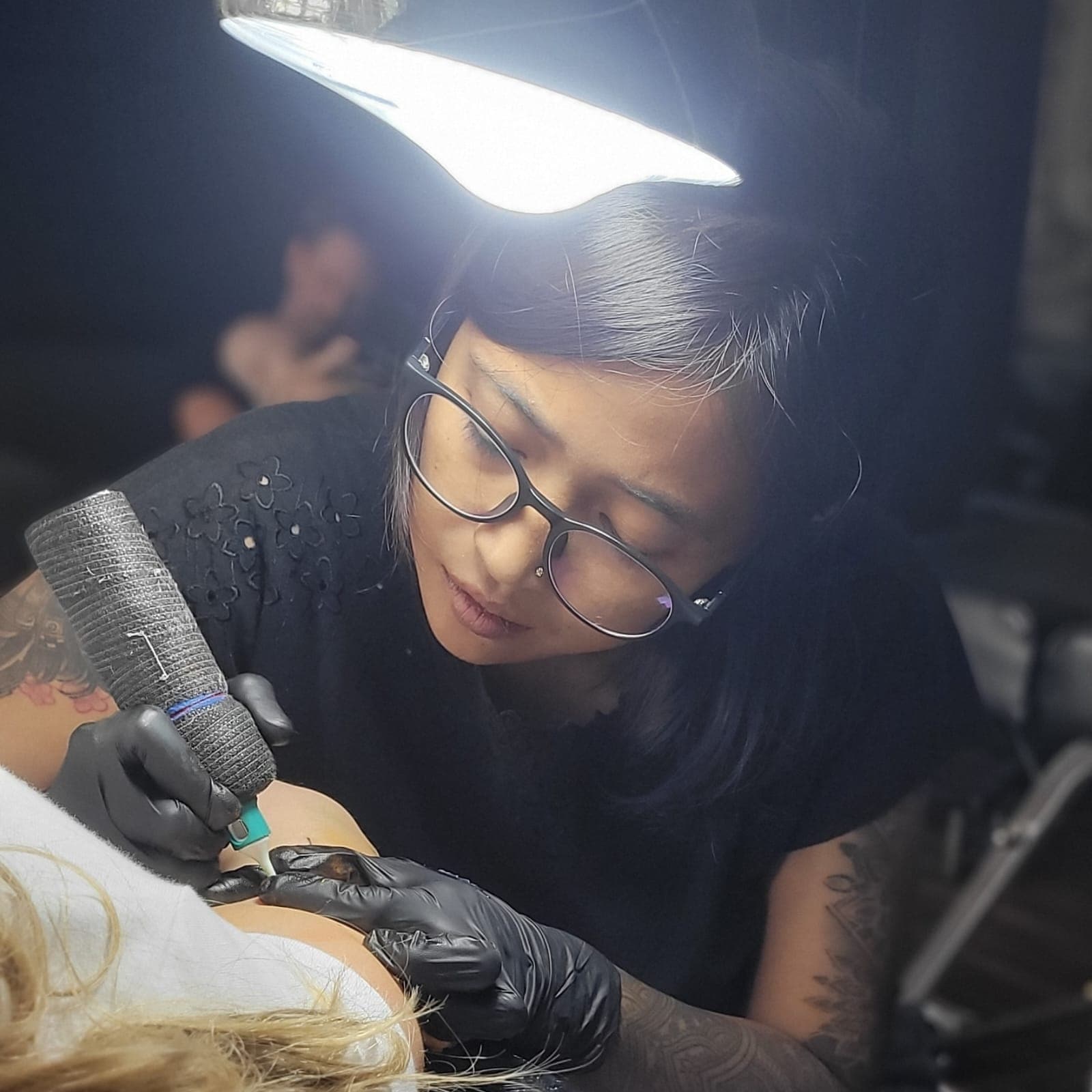 Ichi working on a tattoo at Bali KU Tattoo Studio