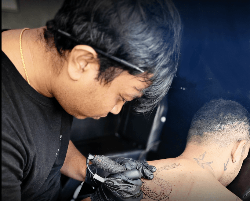 Tattoo artist Nano working in the studio
