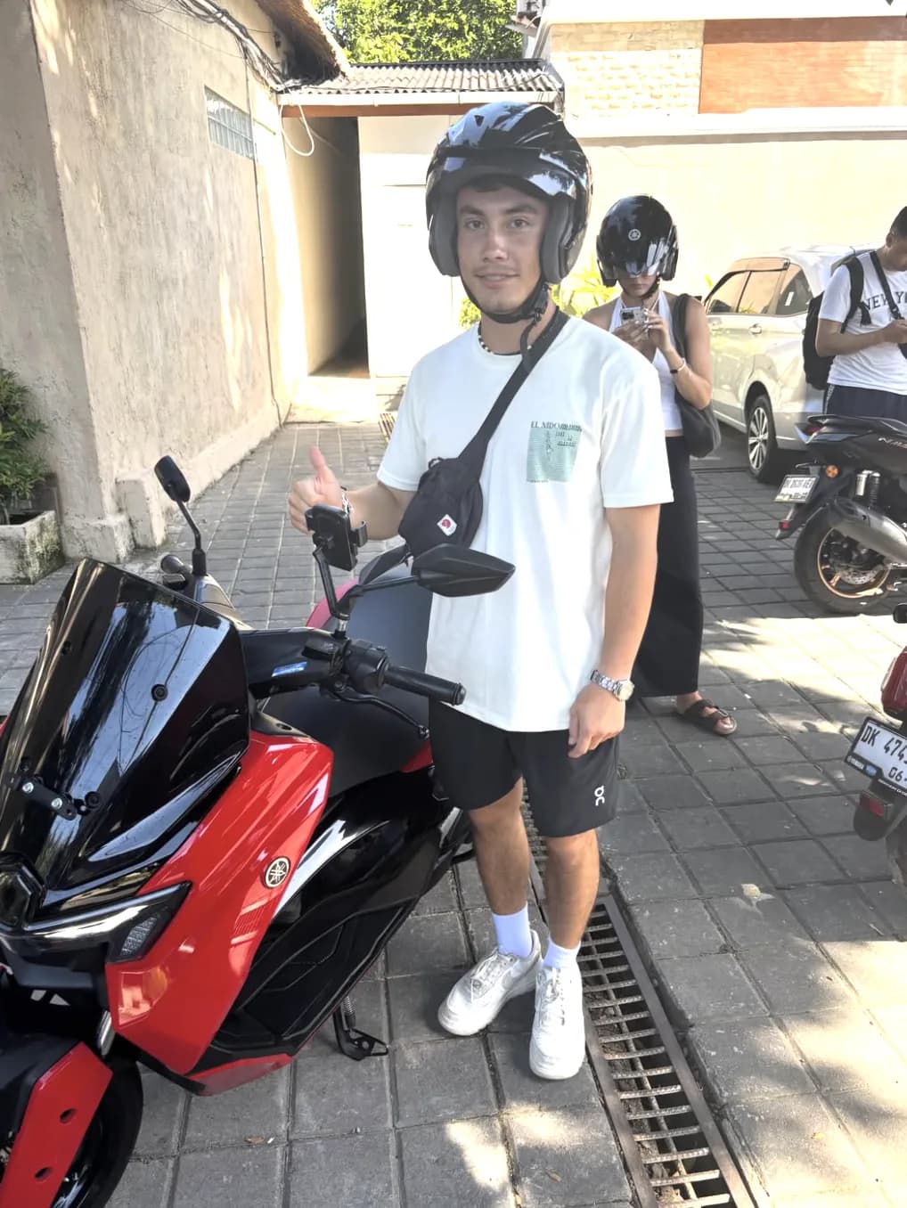 DC Rental Bali customer collecting a red scooter