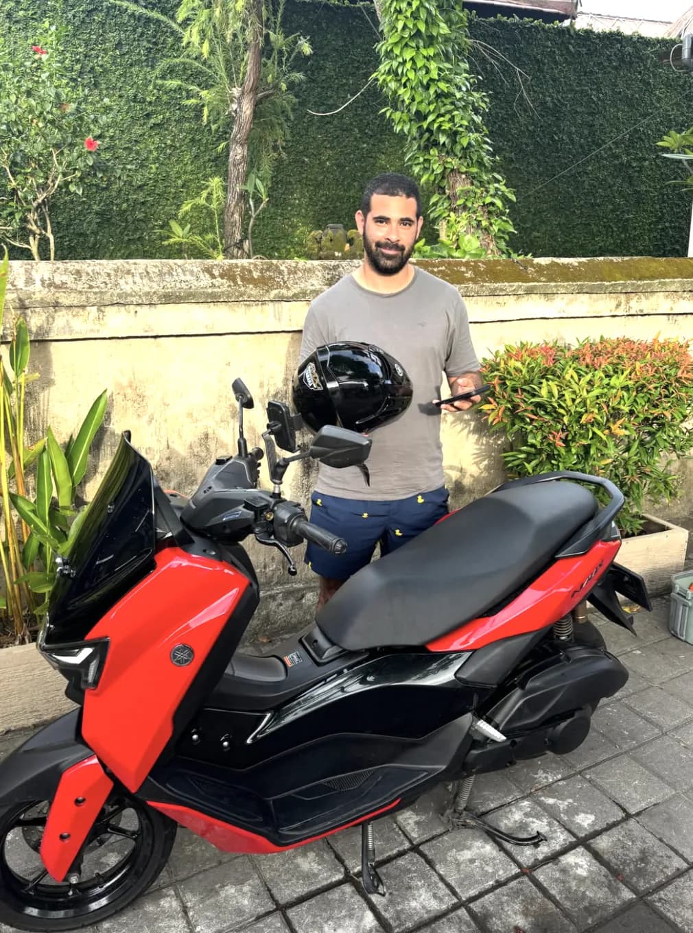 DC Rental Bali customer with a red Yamaha scooter