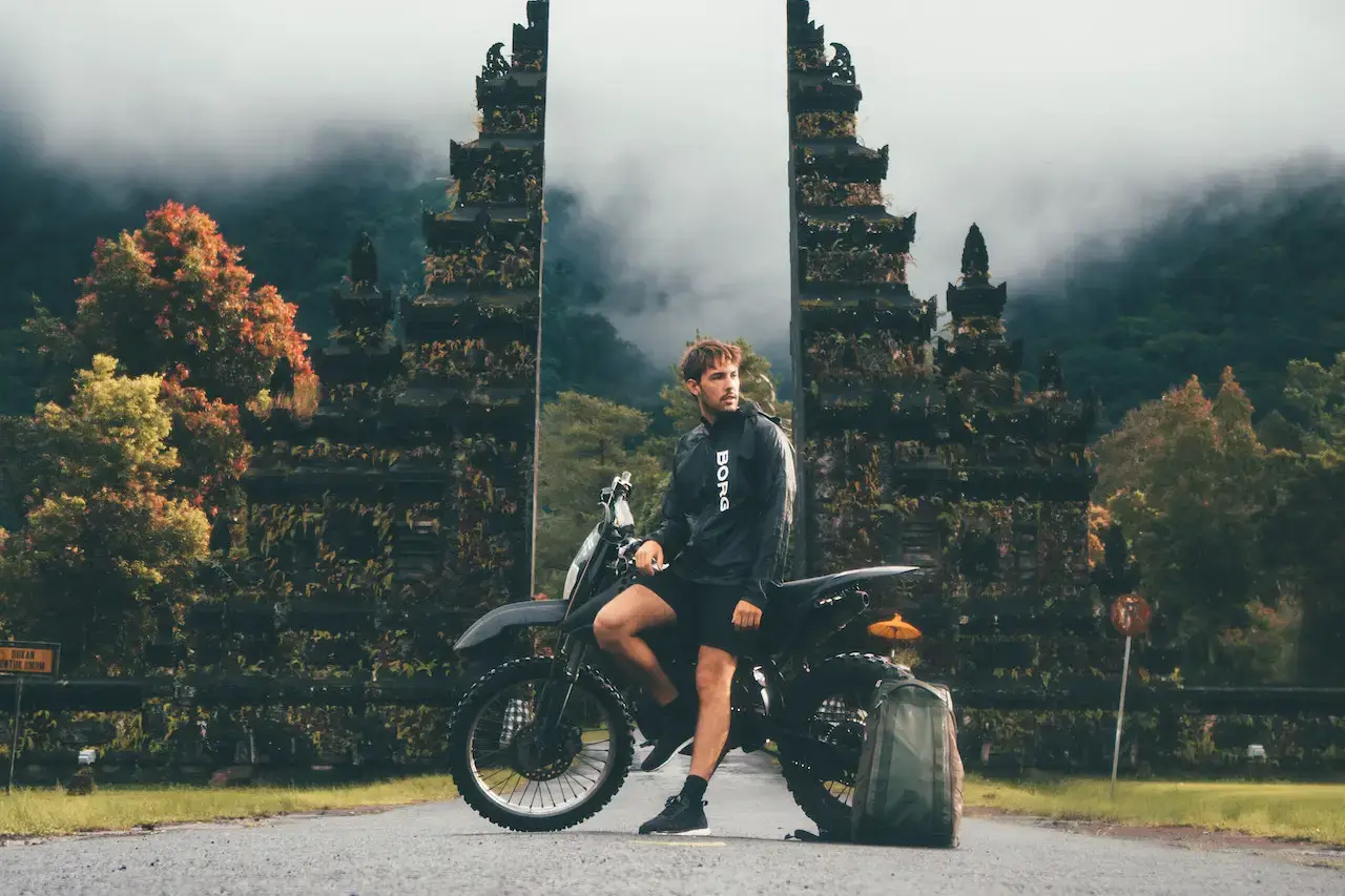 Motorbike rider at a Balinese temple gate